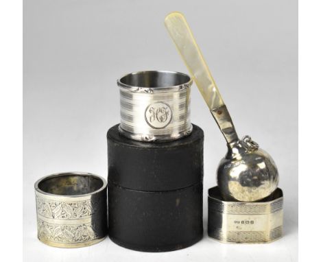 A George V hallmarked silver baby's rattle with mother of pearl handle, Walker &amp; Hall, Birmingham 1932, together with two
