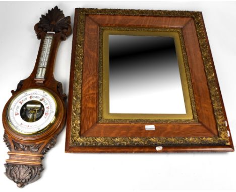 An early 20th century oak wall mirror with ornate applied gilded decoration to the frame, 82 x 71cm and an early 20th century