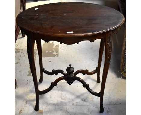 An early 20th century mahogany oval occasional table with shaped frieze, raised on carved slender cabriole supports united by