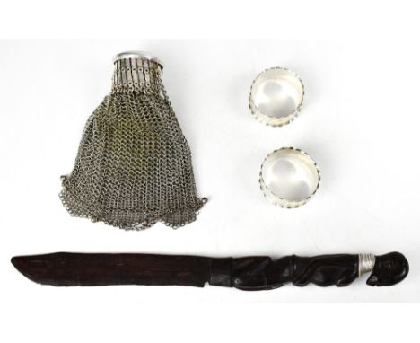 A pair of hallmarked silver napkin rings, an Edwardian white metal chain link evening purse and an African fertility knife (4