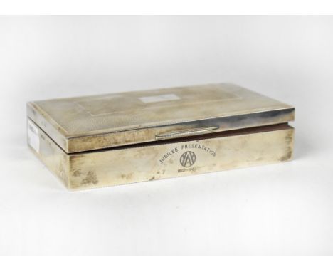 An Elizabeth II hallmarked silver cigarette case of rectangular form, with an engine turned cushioned lid, with blank cartouc