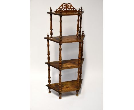 An Edwardian walnut inlaid four-tier whatnot, each tier supported by wrythen turned supports, with urn and foliate inlay to e