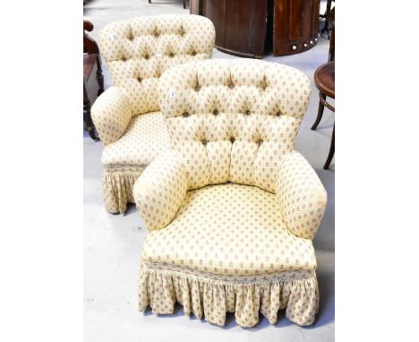 A pair of mid-20th century tub chairs with button backs upholstered in a woven cream material with pink heather within diamon