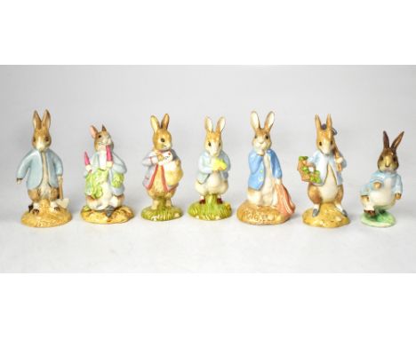 BESWICK AND ROYAL ALBERT; seven Beatrix Potter Peter Rabbit figures to include 'Peter with Daffodils', 'Peter Rabbit Digging'