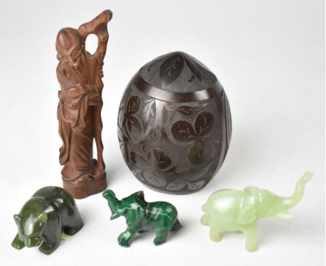 A 19th century coconut shell with four carved panels, one depicting a pineapple, one a three-leaf clover, a Scottish thistle 