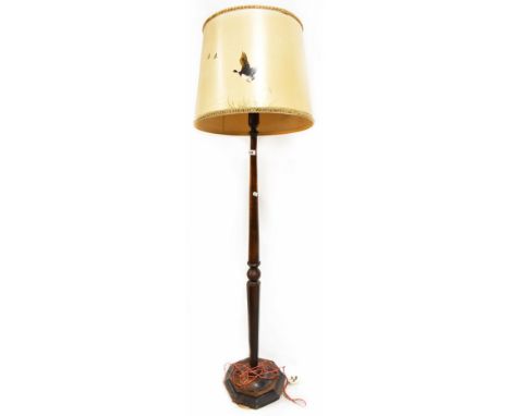 An oak standard lamp on octagonal base, height 158cm (af). CONDITION REPORT The column is slightly loose on the base and the 