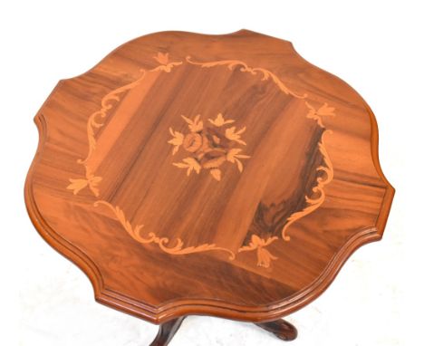 A reproduction Italian inlaid occasional table with shaped top above turned baluster column, to three outswept scrolling supp