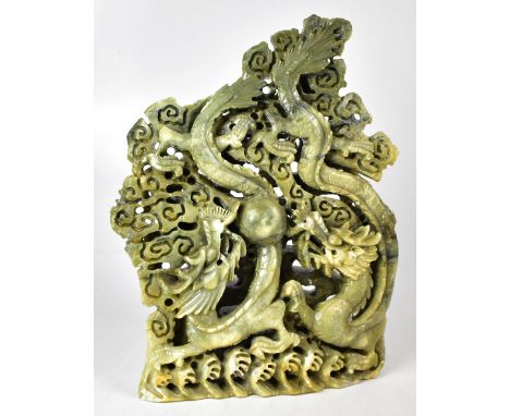 An early/mid-19th century jade green carved hardstone ornament depicting two water dragons chasing the Flaming Pearl of Wisdo