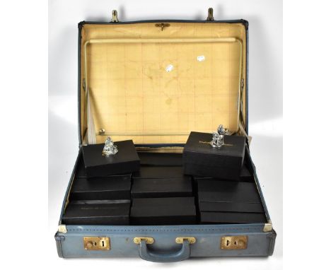 A vintage suitcase containing ten boxed English Miniatures Fine Art Sculpture metal figures, to include postman, policeman, f