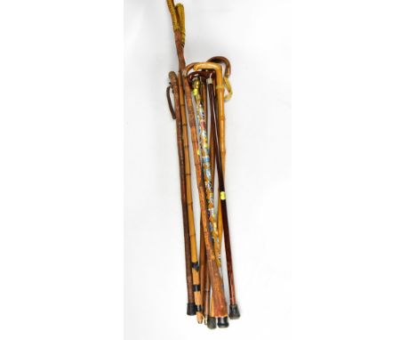 Six various walking sticks to include Africa tourist examples, bamboo, one with brass eagle's head, with town shields attache