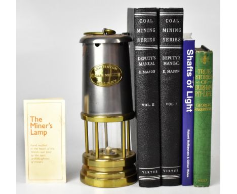 An Ashington Colliery brass and steel safety lamp together with two volumes of E. Mason 'Deputies Manual' from the coal minin