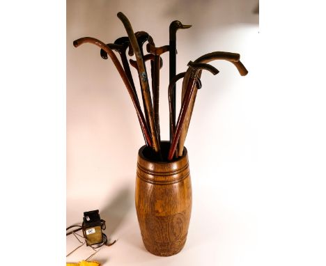 A collection of vintage walking sticks &amp; similar oak barrel shaped stick stand 