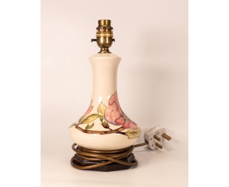 Moorcroft Magnolia lamp base on cream back ground. Height  27.5cm including fittings 
