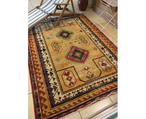 A modern Kazak style carpet with a bold geometric design over a soft yellow field, 240cm x 170cm  