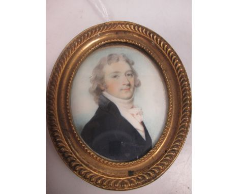 An oval miniature portrait of a gentleman in a gilt gesso frame  