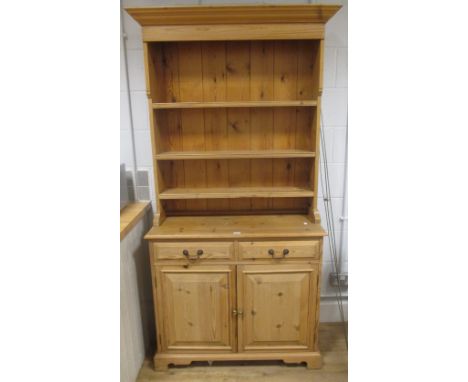 A pine dresser, the three shelf back above two drawers and two cupboards, 94cm high  