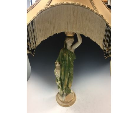 A Royal Worcester figural lamp designed by James Hadley, modelled as a Grecian water carrier, printed marks, date code for 19