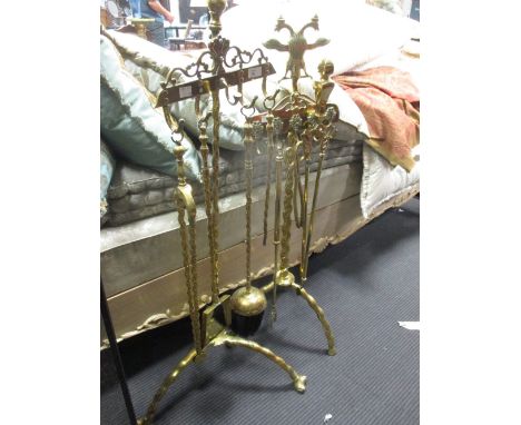 Two brass companion sets, one complete with tools on a twist moulded frame and other fire wares  