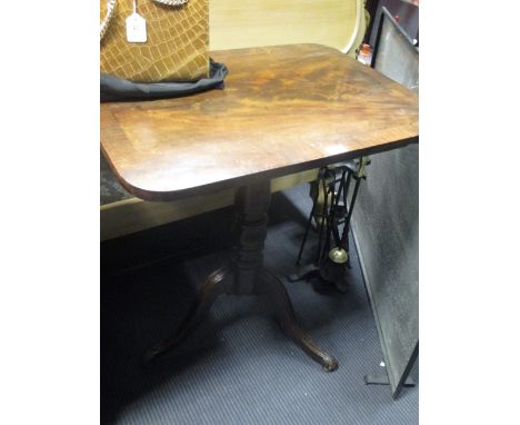 A Regency mahogany tilt-top tripod table, the flame figured rectangular top cross-banded in rosewood, on shell carved feet, 7