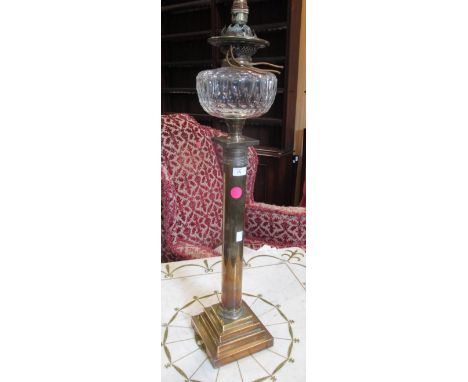 A 19th century brass column oil lamp with glass reservoir, converted to electricty, 85cm high  