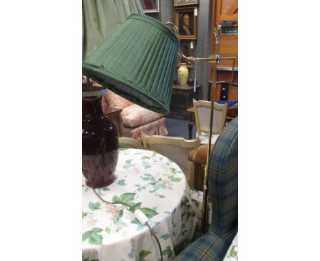 A brass height adjustable floor standing reading lamp  