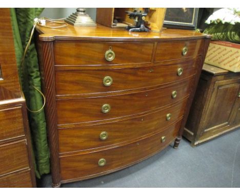 A Regency mahogany bow front chest of drawers, with rope twist column sides, gilt brass ring handles, on gadroon moulded legs