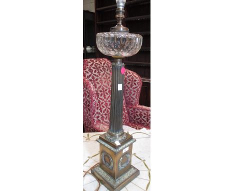 A 19th century brass column oil lamp with glass reservoir, converted to electricity, 79cm high  