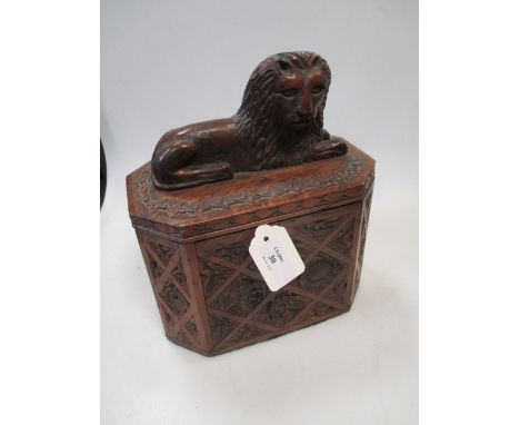 A carved oak caddy box with a carved figure of a recumbent lion to the top, 20 x 13 cms  