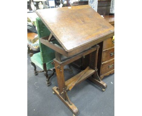 A Victorian oak Gothic reading table, the adjustable top fitted to the underside with an earlier oak panel carved with letter