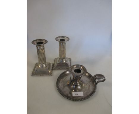 A pair of Victorian silver dwarf candlesticks by William Hutton & Sons, London 1891, with square beaded edged base, reeded co