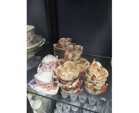 A Japanese Satsuma porcelain tea service for twelve; a pair of continental porcelain imari triangular cups and saucers  