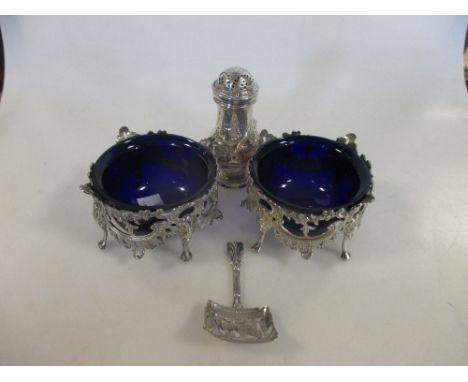 A pair of unmarked pierced circular salts with blue glass liners, a George ll silver pepperette by John Gamon, London 1737, a