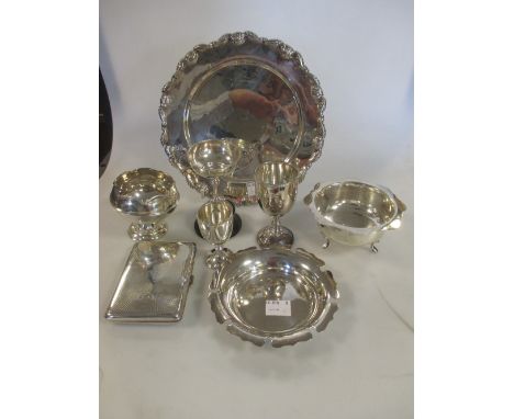 Four small silver trophies, all engraved, a silver bowl on three feet with scalloped edge, a silver pin tray with scalloped e