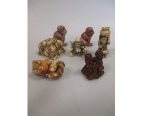 Four late 19th century or early 20th century Japanese carved ivory netsuke, another in boxwood and two soft stone model monke