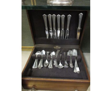 A wooden cutlery canteen marked 'Reed & Barton' containing American silver cultery by Wallace Silversmiths of Conneticut, 'Ca