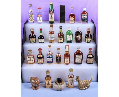 A collection of miniatures mostly spirits whisky and brandy including three Beswick decanters