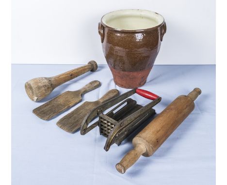 A vintage butter pot, rolling pin, potato chipper, butter pats and meat tenderiser