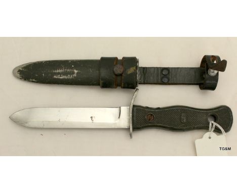 A German fighting knife in its metal scabbard with leather frog. Makers name to the blade Rostfrei Solingen and is 26.5cms lo