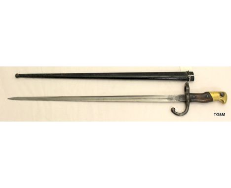 A French Model 1874 Gras Bayonet with T section blade in its steel scabbard. Engraved to the top of the blade Paris-Oudry 187