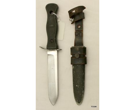 A German fighting knife in its metal scabbard with leather frog. Makers name to the blade Rostfrei Solingen and is 26.5cms lo