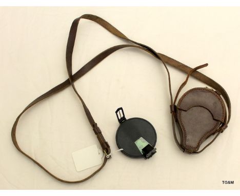 A Prismatic compass in its brown leather case