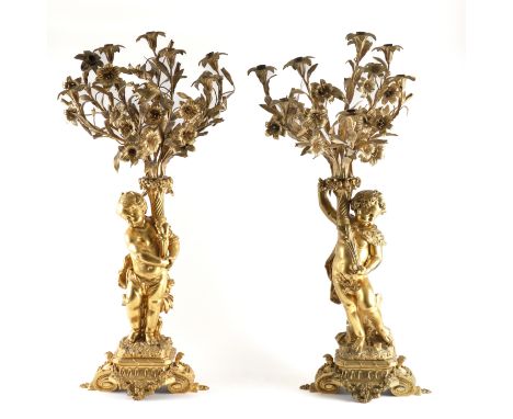 A PAIR OF FRENCH LOUIS XVI STYLE ORMOLU FIGURAL EIGHT LIGHT CANDELABRA (2)Modelled as opposing Putti standing contra-posto, e