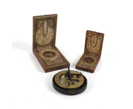 TWO CONTINENTAL PEARWOOD AND PAPER POCKET COMPASS-SUNDIALS (3)Late 18th Century 
With colour heightened lithographic printed 