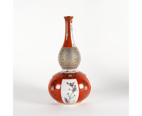 A HEREND IRON-RED GROUND PART RETICULATED DOUBLE GOURD VASE20th century
Painted with Japanese style panels, blue printed and 