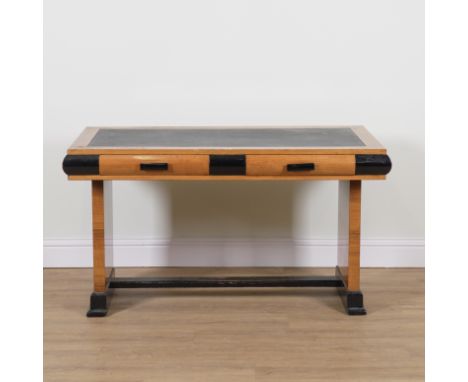 AN ART DECO WALNUT AND EBONISED RECTANGULAR TWO DRAWER WRITING DESKOn slab trestle supports, 138cm wide; 69cm deep; 78cm high