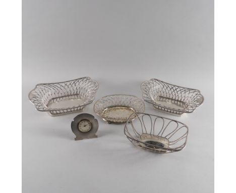 A STERLING SILVER MOUNTED STRUT CLOCK AND FOUR PLATED BASKETS (5)The clock with black Arabic numerals to the engine turned si