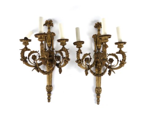 A PAIR OF LOUIS XVI STYLE GILT-BRONZE THREE LIGHT WALL APPLIQUES (2)Early 20th Century 
Each with Bacchus mask mounted taperi