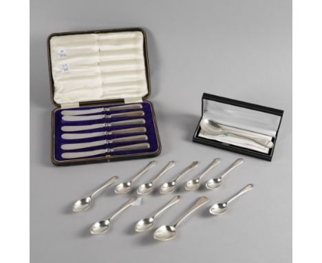 A GROUP OF SILVER FLATWAREComprising; nine golfing spoons, a teaspoon, a christening spoon with a box, combined weight 179 gr