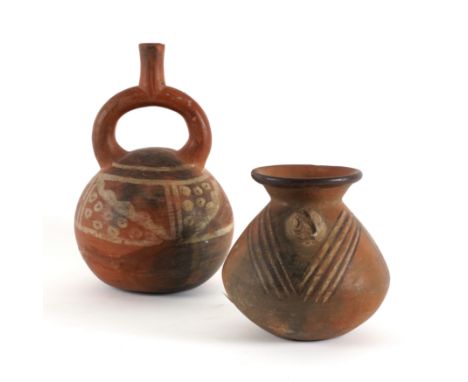 A PERUVIAN TERRACOTTA RED STIRRUP FLASK (2)Huaca del Sol Moche, 450-1400CE
24cm high
Together with a vase with flared rim and