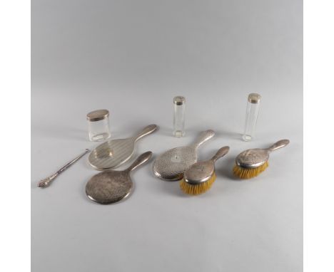 A GROUP OF SILVER MOUNTED DRESSING TABLE AND TOILET WARES (9)Three faceted glass jars, a hand mirror with a pair of matching 